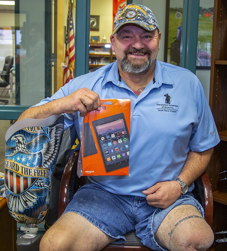 Veteran, Dave Nelson with one of the 25 tablets donated to Great Plains PVA