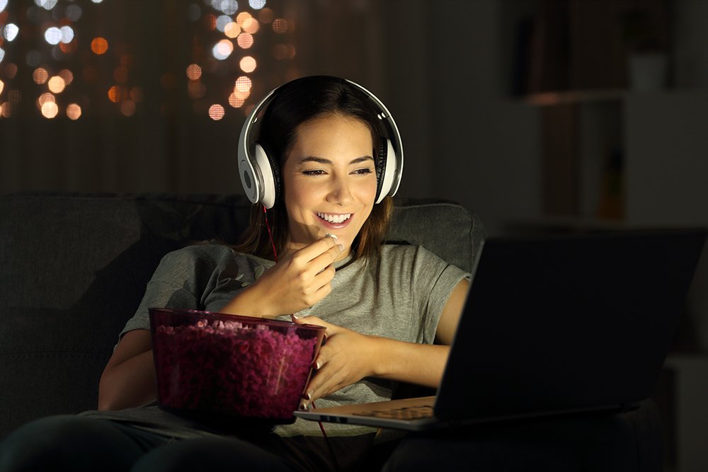 Woman watching online tv in the night