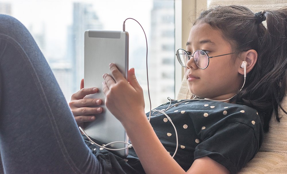 Girl in glasses on tablet