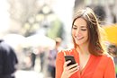 Woman wearing orange shirt texting on the smart phone