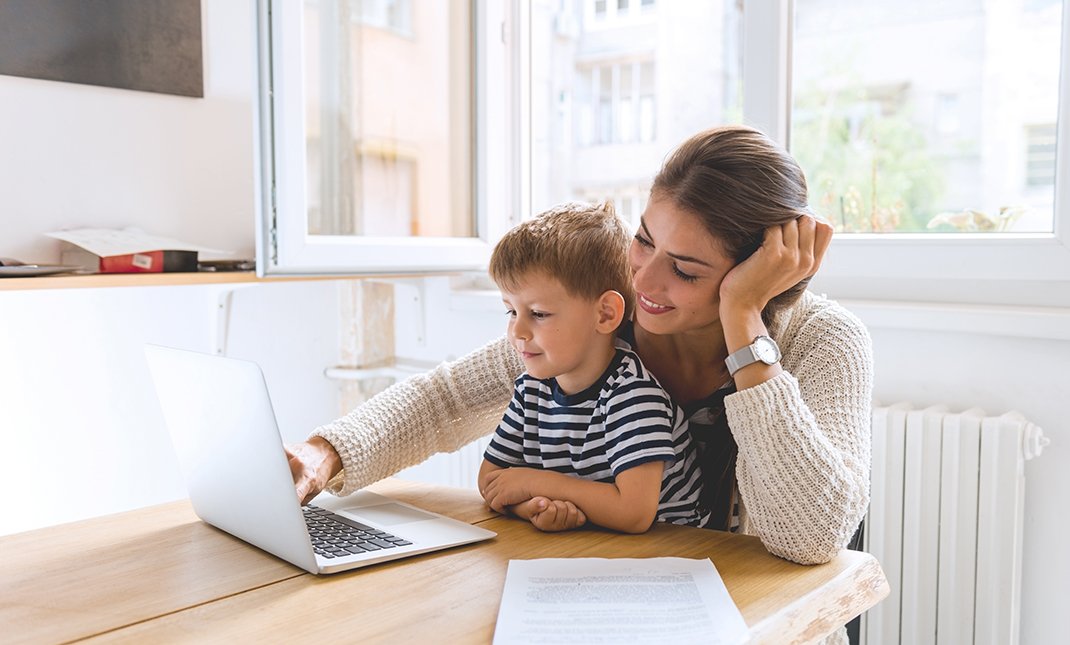 woman working with son on lap