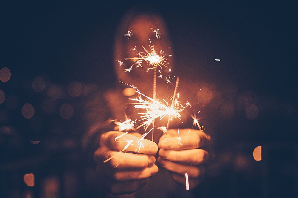 Man holding sparklers in his hands
